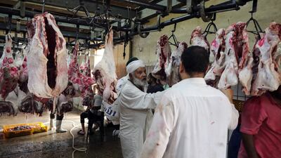 An Egyptian butcher prepares slaughtered sacrificial sheep ahead of Eid Al Adha in Cairo. EPA