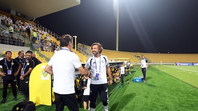 United FC head coach Andrea Pirlo, right, and Al Wasl head coach Rui Vitoria shake hands.