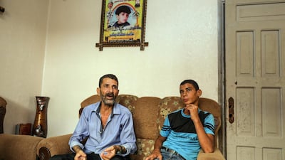 Ahed Bakr sits with Montaser Baker, his 17-year-old son, in his home in Gaza City. Majed Mahmoud for The National
