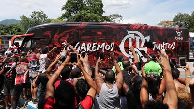Flamengo supporters alongside the team bus outside their training centre. Reuters