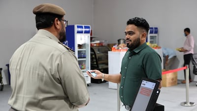 Mr Ahire speaks to an official of the General Directorate of Residency and Foreigners Affairs during the UAE visa amnesty programme