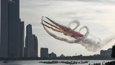 The Al Fursan aerobatic team light up the skyline of Abu Dhabi. Khushnum Bhandari / The National