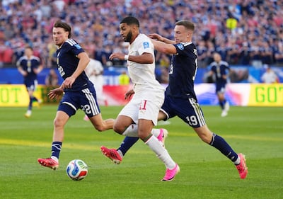 Morocco's Ismael Saibari in action with Scotland's Lewis Ferguson and Nathan Patterson. Reuters