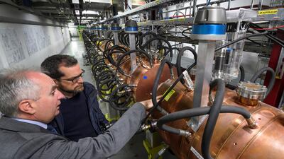 Guests of the European Organisation for Nuclear Research (CERN) visit the Linac 4 accelerator on May 9, 2017 in Meyrin near Geneva. CERN inaugurates its linear accelerator, Linac 4 due to feed the CERN accelerator complex with particle beams of higher energy, which will allow the LHC to reach higher luminosity by 2021. It will become the first step in CERN’s accelerator chain, delivering proton beams to a wide range of experiments. / AFP PHOTO / Fabrice COFFRINI