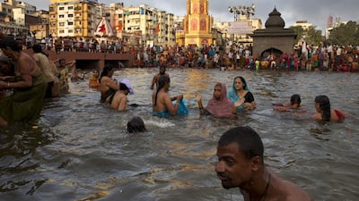 Indian pilgrims take holy dips in the Godavari River.