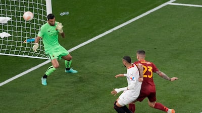 Roma's Gianluca Mancini, right, scores an own goal to level the scores. AP