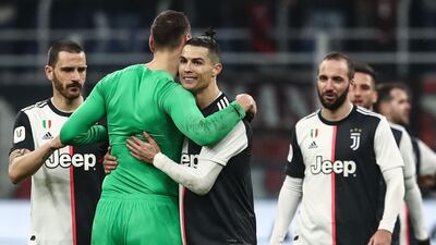 Cristiano Ronaldo embraces AC Milan goalkeeper Gianluigi Donnarumma after the match. AFP