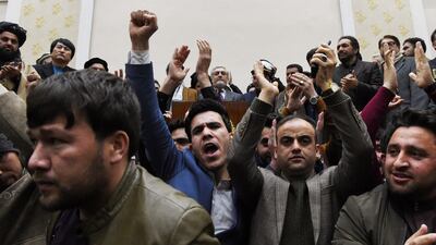 People cheer as Afghan presidential election opposition candidate Abdullah Abdullah (C) gives a press conference after the announcement of the final presidential elections results at the Sapedar Palace in Kabul on February 18, 2020. Afghan presidential election loser Abdullah Abdullah on February 18 contested final results that declared his rival Ashraf Ghani the winner of last year's poll, vowing he would form his own parallel government. Afghan election officials said final results showed he had won 39.52 percent of last September's vote, while Ghani had taken 50.64 percent. / AFP / WAKIL KOHSAR
