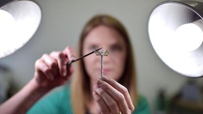 Lauren Wethers, a goldsmith at Steensons jewellers in Glenarm, puts the finishing touches to a Game of Thrones Dire Wolf sterling silver brooch pin. Charles McQuillan / Getty Images