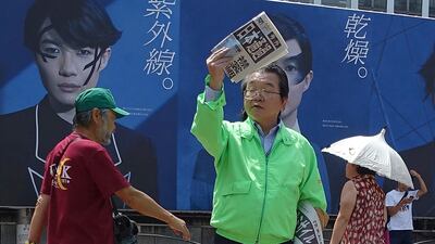 A staff of a Japanese newspaper hands out passer-by an extra newspaper reporting North Korea's rocket launch at a shopping street in Tokyo Tuesday, August 29, 2017. Mari Yamaguchi / AP Photo