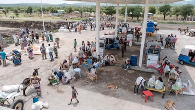 People gather at a petrol station during food distribution near Humera, in the Tigray region of Ethiopia. AFP