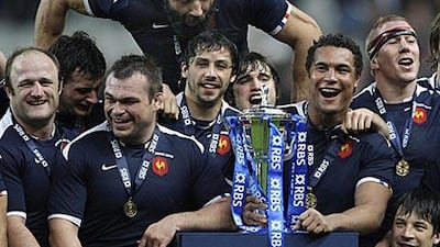 The French players celebrate their victory over England which earned them the Six Nations Grand Slam.