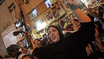 A libyan woman raises a rifle as tens of thousands of Libyans celebrate what the rebels claim to be the first uprising in Tripoli against the Kadhafi's regime on August 21, 2011 at freedom square in Benghazi, Libya. Several explosions and heavy gunfire were heard late Saturday in Tripoli, as witnesses reported fighting in some neighbourhoods of the Libyan capital. Gunfire erupted in central Tripoli after the break of the dawn-to-dusk fast of Ramadan. AFP PHOTO / GIANLUIGI GUERCIA *** Local Caption *** 649210-01-08.jpg