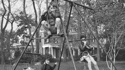 In this October 1934, Robert F. Kennedy, top front, Edward M. Kennedy, left rear, and Jean Kennedy, right rear, play on a swing set in Bronxville, N.Y. Kennedy Family Collection / John F. Kennedy Library Foundation via AP
