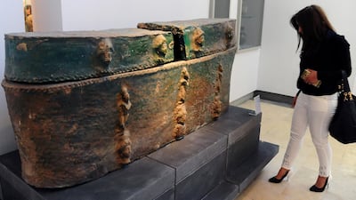 In this photo released by the Syrian official news agency SANA, a visitor looks at ancient artifacts during the reopening ceremony for Syria's National Museum, in Damascus, Syria, Sunday.