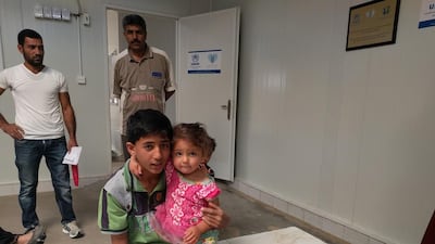 Retaj Atma, 3, and her brother Omar at the Zaatari Refugee Camp. Thaer Zriqat / The National