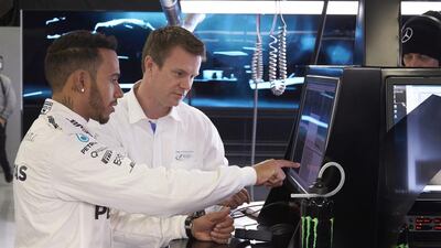 Lewis Hamilton checks racing data. Courtesy Tata Communications