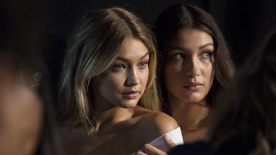 Models Gigi Hadid, left, and Bella Hadid pose for photos backstage before the Tommy Hilfiger Spring/Summer 2016 collection presentation during New York Fashion Week. Andrew Kelly / Reuters