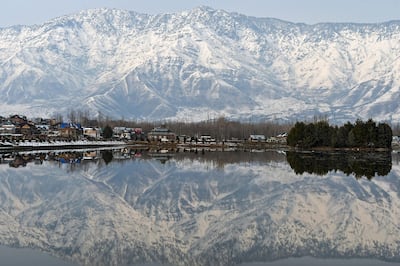 Snow-covered mountains are reflected in Dal Lake in Srinagar, the summer capital of Kashmir, where Akraam grew up. Photo: AFP