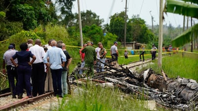 Rescue and search workers on the site where a Cuban airliner with more than 100 passengers on board plummeted into a yuca field just after takeoff from the international airport in Havana, Cuba, Friday, May 18, 2018. (AP)