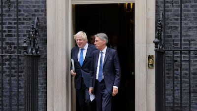 British Chancellor Philip Hammond and Foreign Secretary Boris Johnson - usually seen at opposite ends of the government's hard/soft Brexit axis - depart together after a Cabinet meeting at 10 Downing Street in London, Thursday, Sept. 21, 2017.
