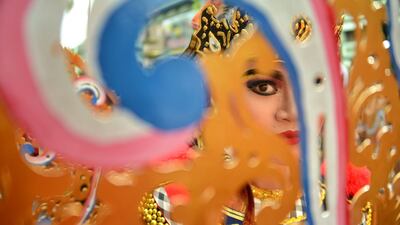 A Balinese girl takes part in a traditional dance during in a cultural parade at a festival to mark the New Year in Denpasar on Bali island. Sonny Tumbelaka / AFP