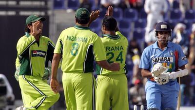 Pakistan medium-pacer Rana Naved-ul-Hasan celebrates with captain Inzamam-ul-Haq and another teammate after India captain Rahul Dravid is run out. AFP