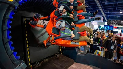 Attendees try the DOF Robotics Hurricane 360 VR ride. AFP