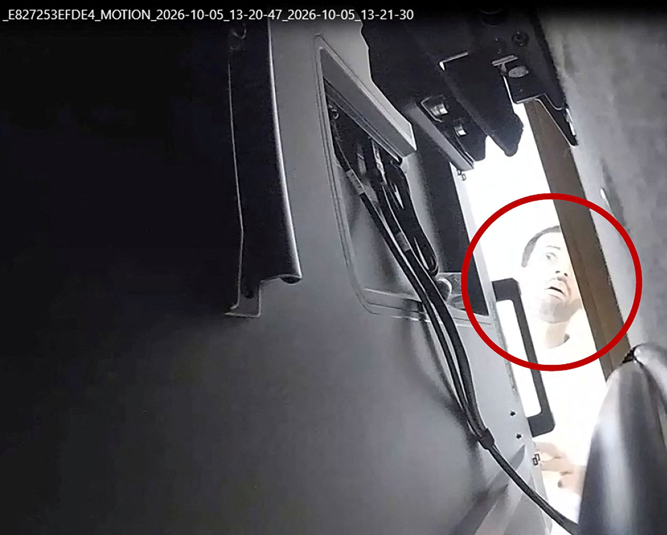 A man described as Abdulrahman Alfozan looks behind a television where a recording device had been placed in a conference room at OpenAI main offices in San Francisco, California. Photo: US Department of Justice via Reuters