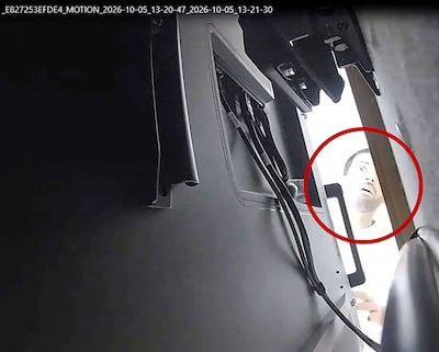 A man described as Abdulrahman Alfozan looks behind a television where a recording device had been placed in a conference room at OpenAI main offices in San Francisco, California. Photo: US Department of Justice via Reuters