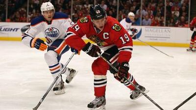 Chicago Blackhawks' Jonathan Toews takes the puck past Edmonton's Jeff Petry.