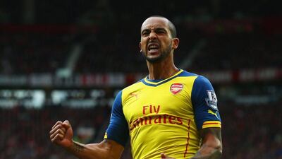 Arsenal's Theo Walcott celebrates Tyler Blackett's own goal on Sunday in his side's 1-1 Premier League draw with Manchester United. Clive Rose / Getty Images / May 17, 2015