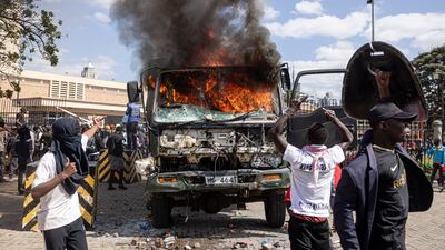 A police vehicle burns in front of parliament. Getty images