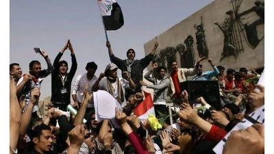 A man waves the Iraqi flag as protesters chant anti-government slogans during a demonstration in Baghdad on Friday.