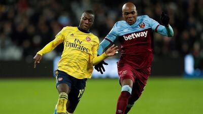 Arsenal midfielder Nicolas Pepe vies with West Ham United defender Angelo Ogbonna. AFP