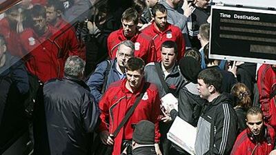 Liverpool players prepare for their journey to Spain to face Atletico Madrid in the Europa League at Runcorn station.