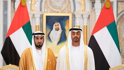 Sheikh Mohamed bin Zayed stands for a photograph with Major General Faris Khalaf Al Mazrouei during the swearing-in ceremony. Ministry of Presidential Affairs