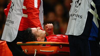Robin van Persie is stretchered off during the match against Olympiakos on Wednesday. Laurence Griffiths / Getty Images / March 19, 2014