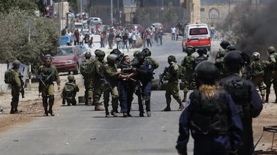 Israeli soldiers arrest a protester near the West Bank village of Beita, near Nablus, on May 26, 2017, a day before Palestinian prisoners in Israeli jails called off their hunger strike. Alaa Badarneh / EPA