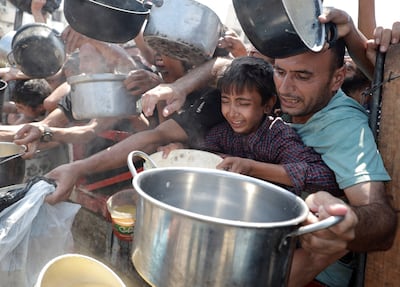 Palestinians gather to receive food from a charity kitchen in Gaza city on Monday. Reuters