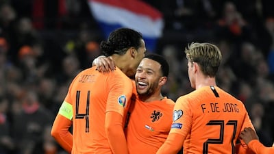 Van Dijk celebrates scoring their fourth goal with Depay and De Jong. Reuters