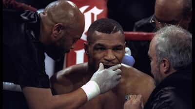Mike Tyson sits in his corner between rounds.