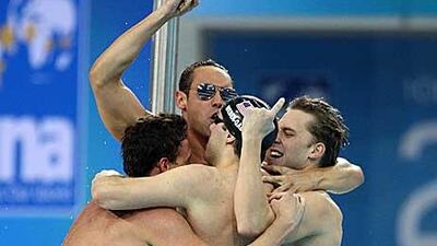 The victorious US team hug after winning the men´s 4x100-metre medley relay yesterday.