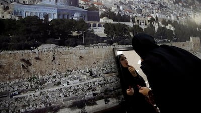 A Palestinian bride applies makeup during a mass wedding in Ramallah, in the occupied West Bank. Palestinian grooms and brides participated in a mass wedding ceremony in the city of Ramallah, the West Bank. Reuters