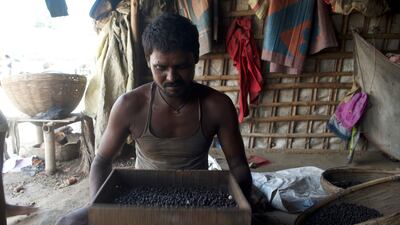 Santosh Shani sieves the seeds to get rid of any stones