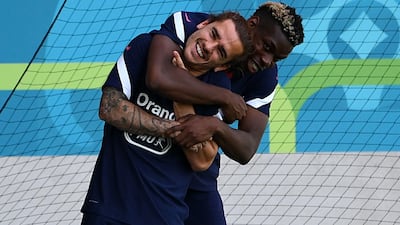 Paul Pogba and Antoine Griezmann share a joke during a training session in Munich. AFP