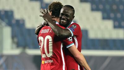 Liverpool's Portuguese striker Diogo Jota is congratulated by Liverpool's Senegalese striker Sadio Mane after scoring. AFP