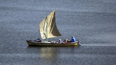 A fisherman travels on a boat in the Suez Canal. The waterway is one of Egypt’s main sources of foreign currency. Amr Abdallah Dalsh / Reuters