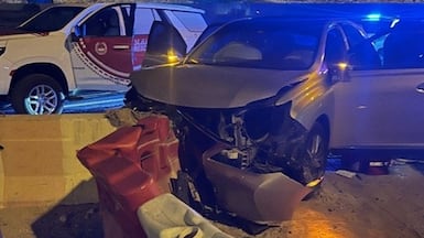 A driver and a passenger were injured after their car crashed into a barrier on Mohamed bin Zayed Road. Photo: Dubai Police.