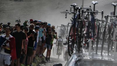 Spectators watch as France's Fabien Grellier, rear, pedals in the ascent of the Plateau des Glieres during the 10th stage of the Tour de France between Annecy and Le Grand-Bornand. Jeff Pachoud / AFP